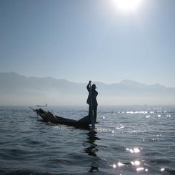 Rudernder Mann auf einem See 